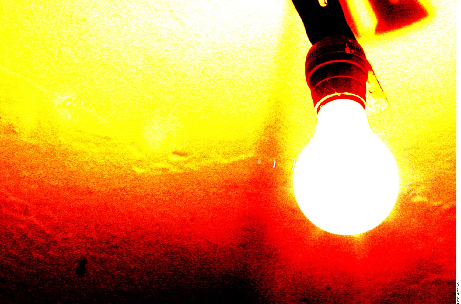Bombilla incandescente brillante encendida contra un fondo degradado de colores cálidos que van del amarillo al rojo oscuro.
