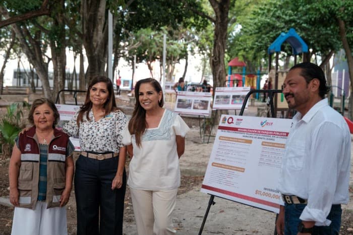 Funcionarios y representantes presentan un proyecto de rehabilitación de parque en evento público con cartel informativo.
